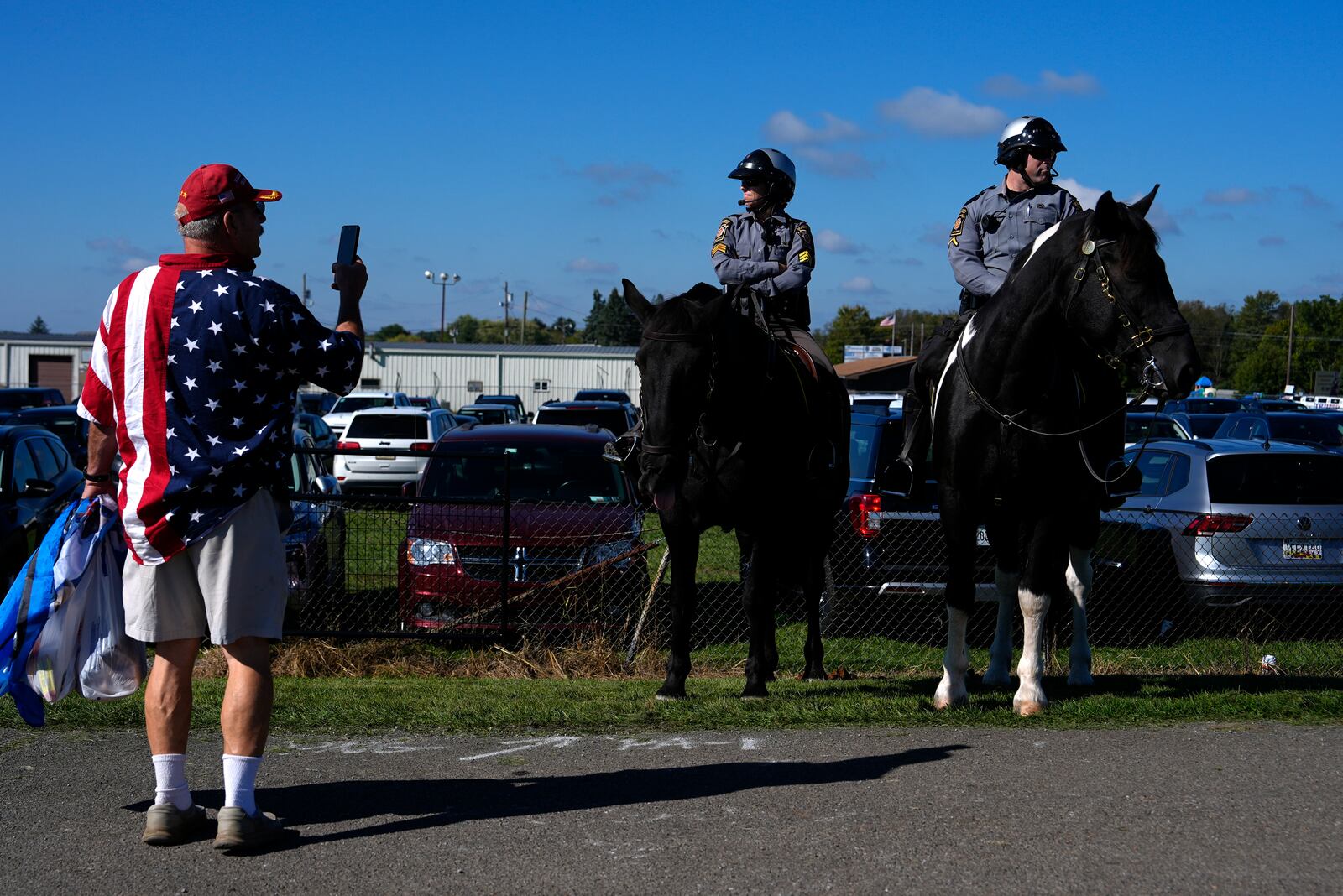 Law enforcement on horseback watch as supporters arrive before Republican presidential nominee former President Donald Trump speaks at a campaign rally at the Butler Farm Show, Saturday, Oct. 5, 2024, in Butler, Pa. (AP Photo/Julia Demaree Nikhinson)