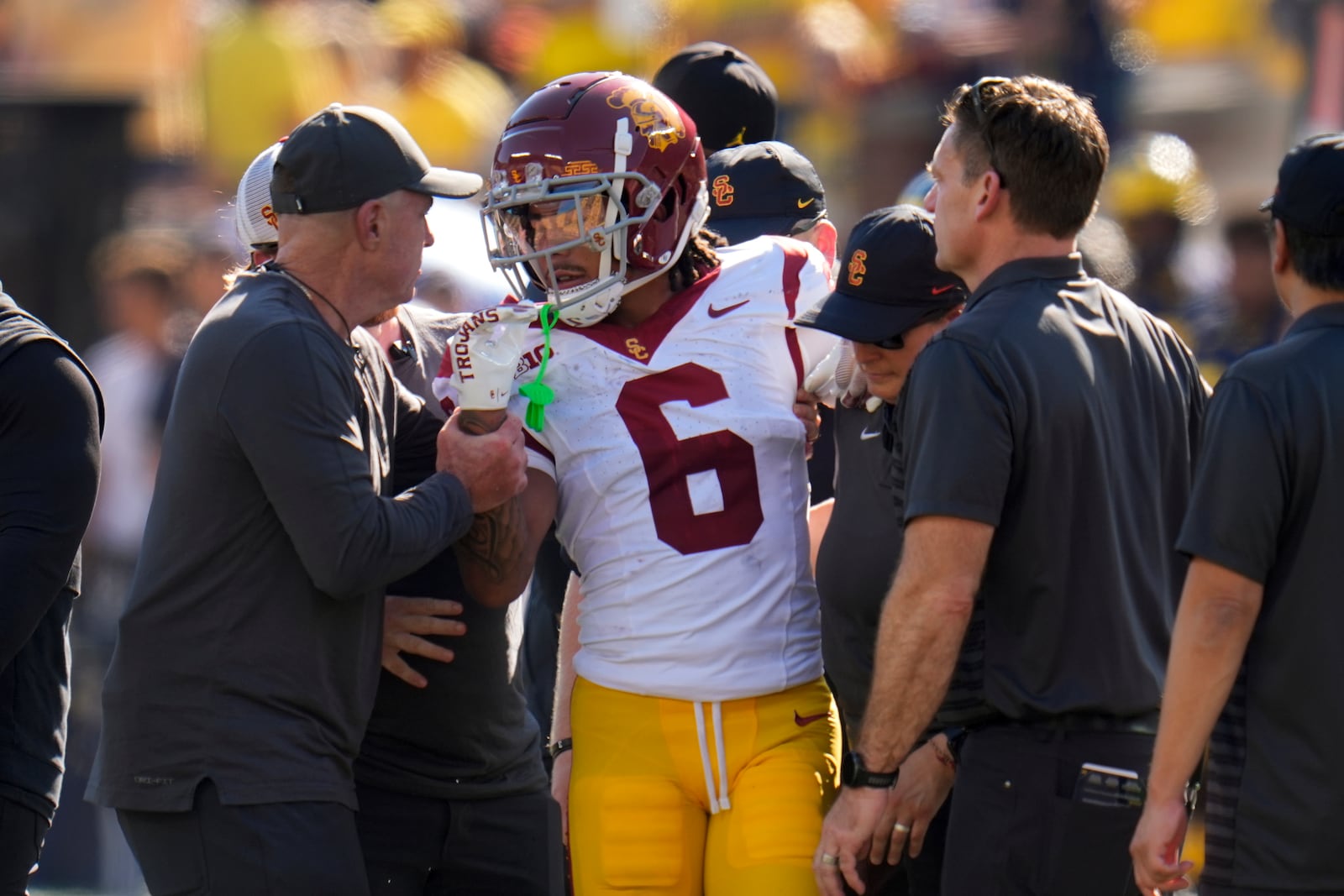 Southern California wide receiver Makai Lemon (6) is helped off the field in the first half of an NCAA college football game against Michigan in Ann Arbor, Mich., Saturday, Sept. 21, 2024. (AP Photo/Paul Sancya)