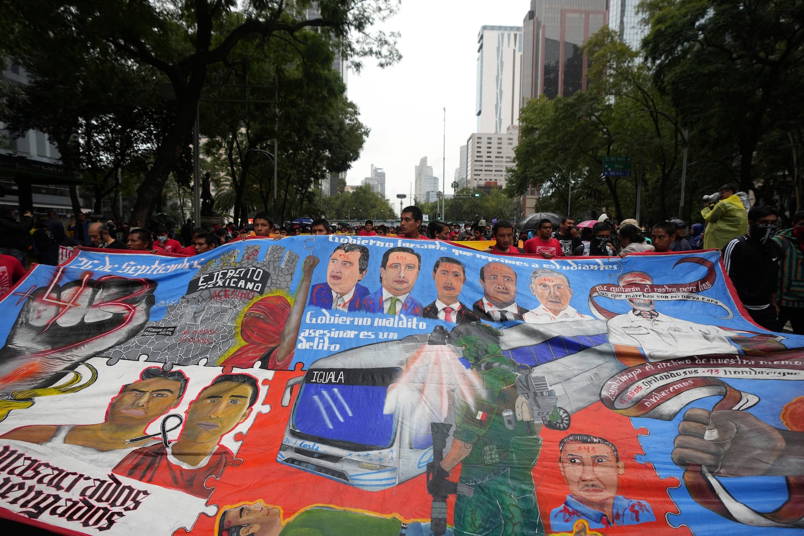 Families and friends take part in a demonstration marking the 10-year anniversary of the disappearance of 43 students from an Ayotzinapa rural teacher's college, in Mexico City, Thursday, Sept. 26, 2024. (AP Photo/Fernando Llano)