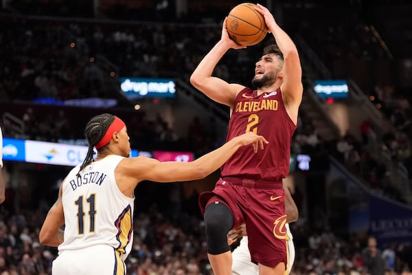 Cleveland Cavaliers guard Ty Jerome (2) shoots over New Orleans Pelicans guard Brandon Boston (11) in the second half of an NBA basketball game, Wednesday, Nov. 20, 2024, in Cleveland. (AP Photo/Sue Ogrocki)