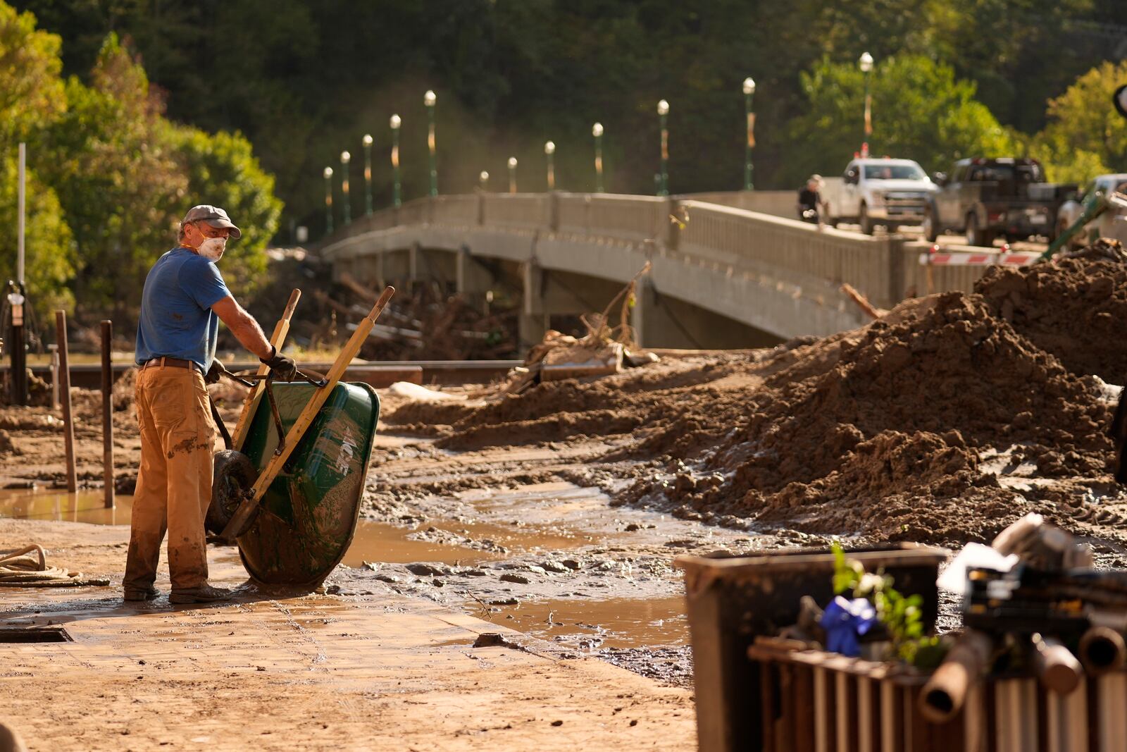 FILE - Brian McCormack pauses after using a wheelbarrow to clean up debris left in the aftermath of Hurricane Helene, Oct. 1, 2024, in Marshall, N.C. (AP Photo/Jeff Roberson)