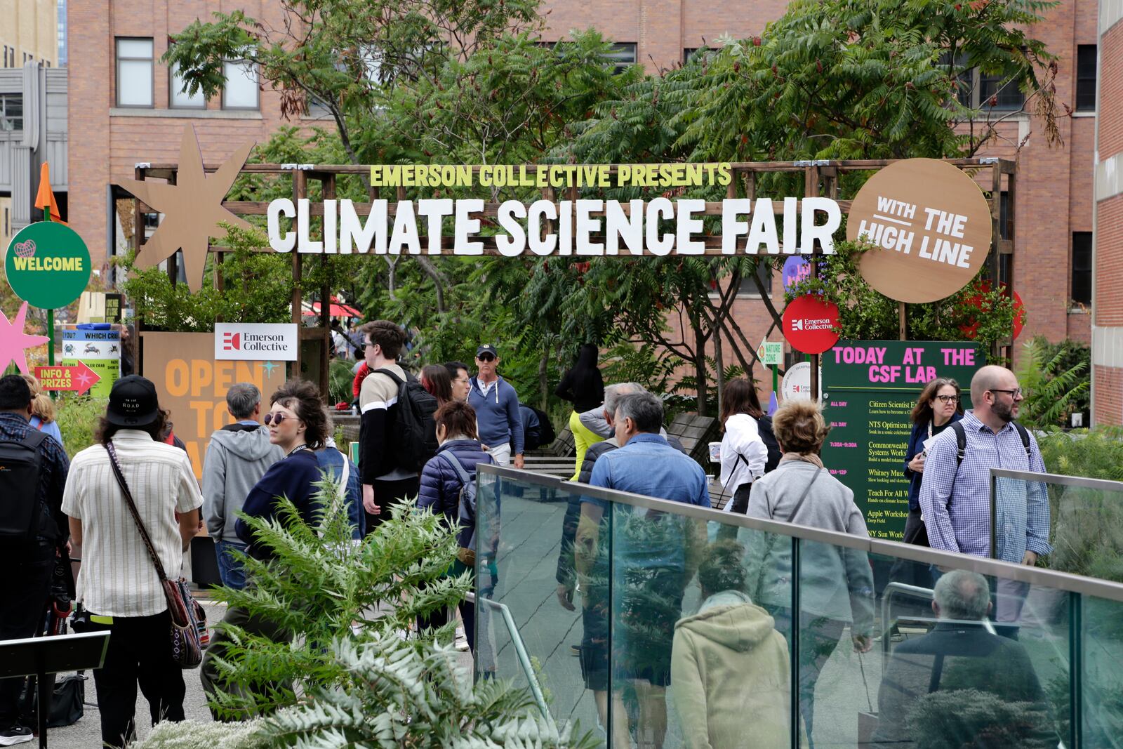 People arrive at the Climate Science Fair, an outdoor exhibit hosted by the Emerson Collective during the annual Climate Week NYC and United Nations General Assembly, on Monday, Sept. 23, 2024 in New York. (AP Photo/Peter Morgan)