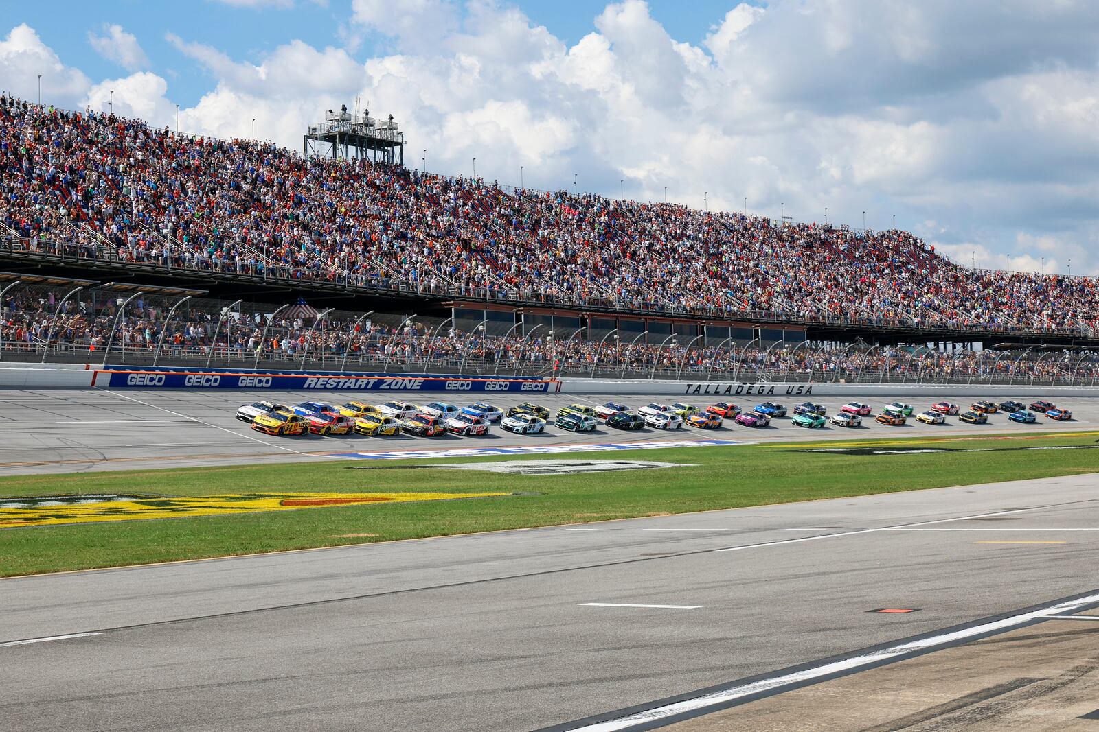 Driver Michael McDowell (34) leads the pack to the start of a NASCAR Cup Series auto race at Talladega Superspeedway, Sunday, Oct. 6, 2024, in Talladega, Ala. (AP Photo/ Butch Dill)