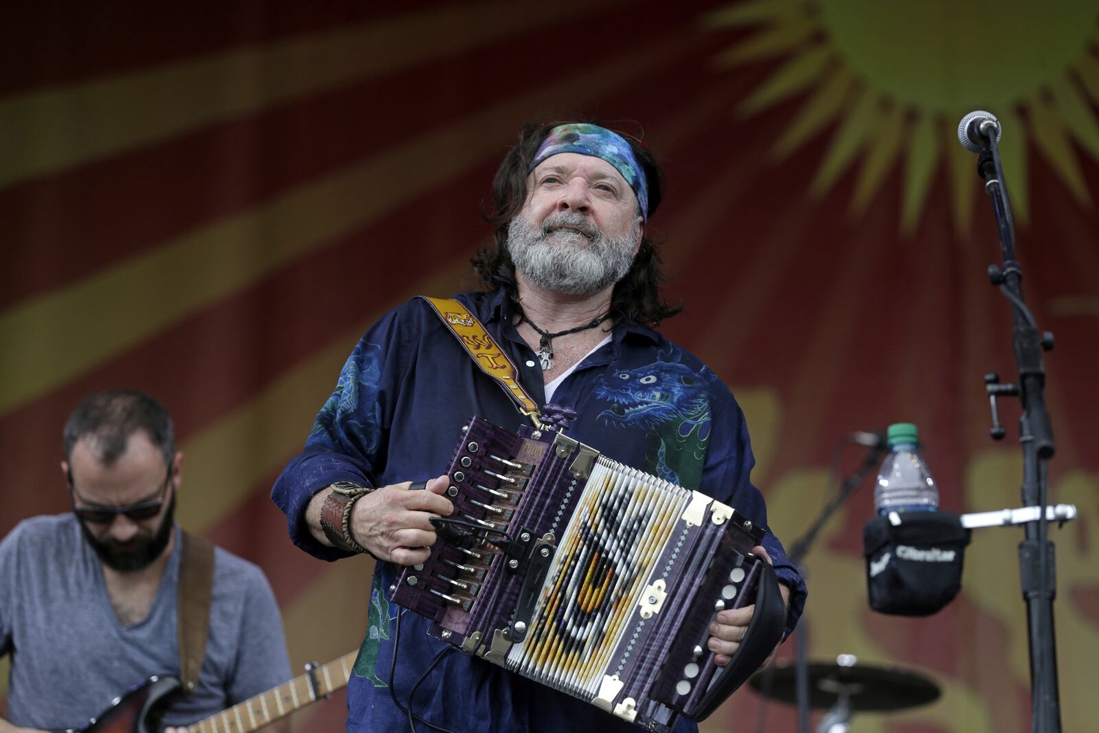 FILE - Zydeco artiest Wayne Toups plays the accordion and sings at the New Orleans Jazz and Heritage Festival in New Orleans, Friday, April 24, 2015. (AP Photo/Gerald Herbert, File)