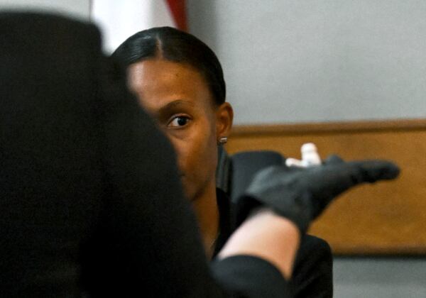 Prosecutor Sheila Ross holds an AirPod earpiece Laken Riley worn as GBI Crime Scene Specialist Daniella Stuart testifies on the witness stand during the trial of Jose Ibarra, accused of killing a Georgia nursing student earlier this year, at Athens-Clarke County Superior Court, Friday, Nov. 15, 2024, in Athens, Ga. (Hyosub Shin/Atlanta Journal-Constitution via AP, Pool)