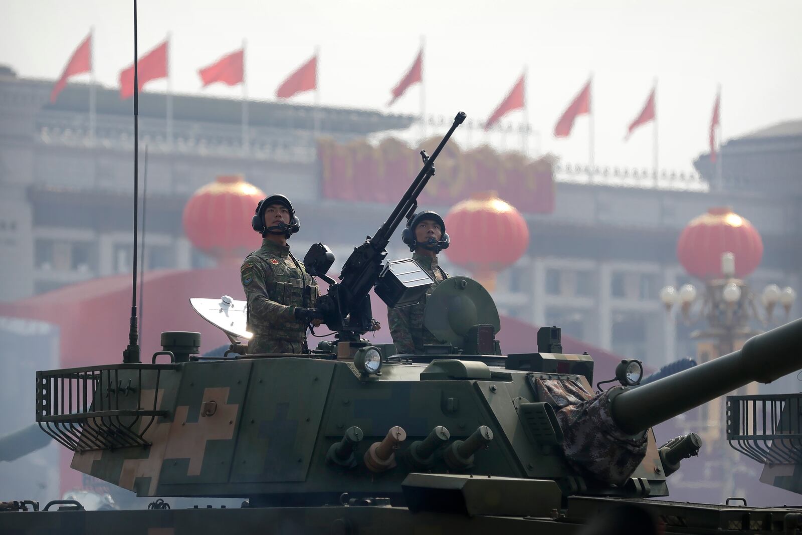 FILE - Chinese tank crew members stand at attention during a parade to commemorate the 70th anniversary of the founding of Communist China in Beijing, Tuesday, Oct. 1, 2019. (AP Photo/Mark Schiefelbein, File)