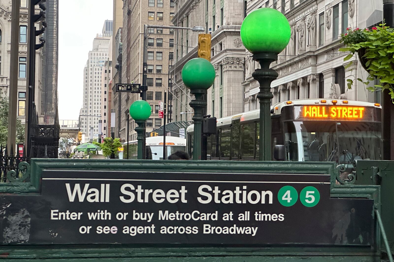 A bus passes the Wall St. subway station on Wednesday, Sept. 18, 2024, in New York. (AP Photo/Peter Morgan)