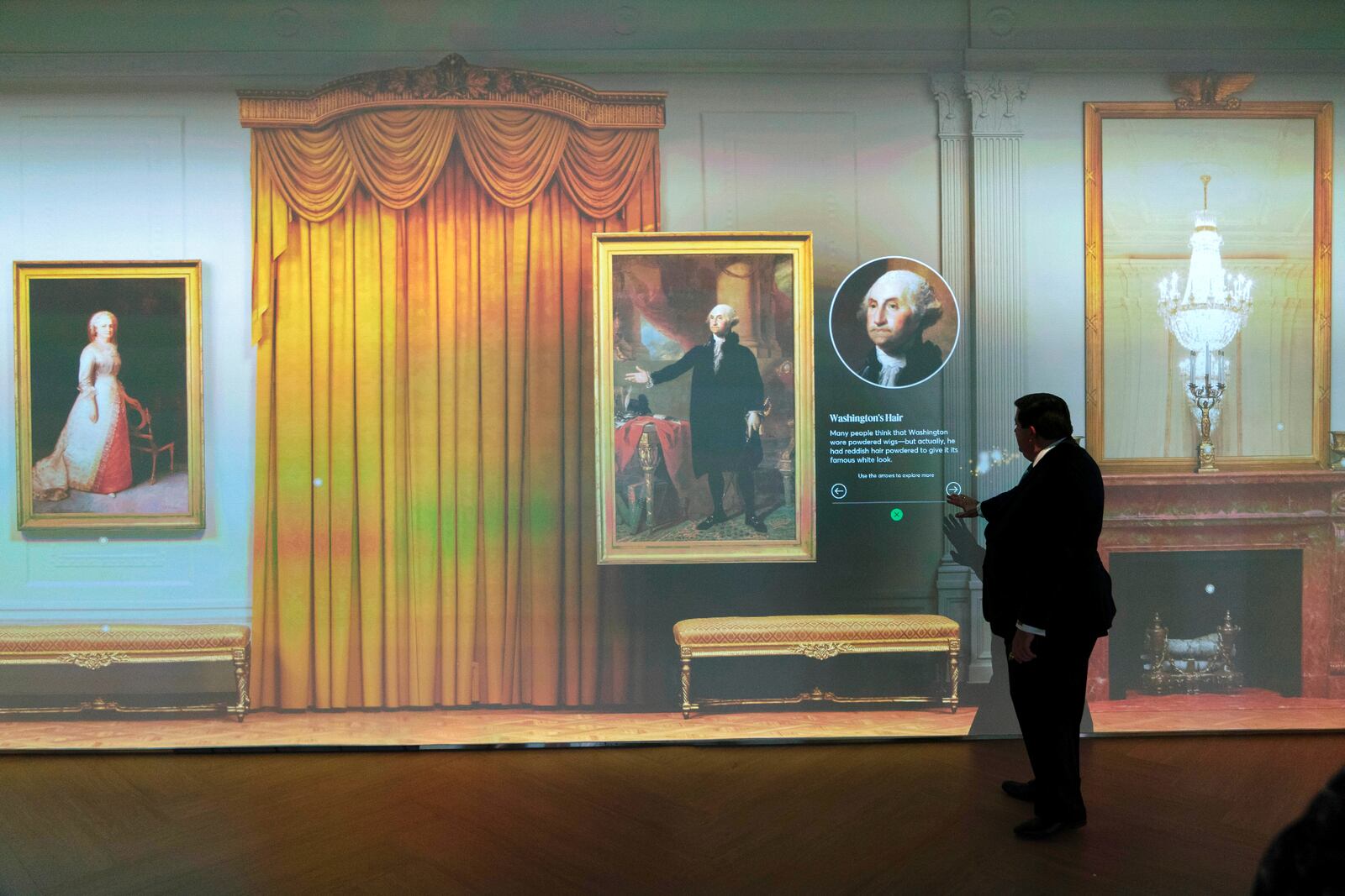 White House Historical Association President Stewart McLaurin tour members of the media in an interactive 3D room of the White House East Room as is today, shown at The People's House exhibit, Monday, Sept. 16, 2024 in Washington. (AP Photo/Jose Luis Magana)