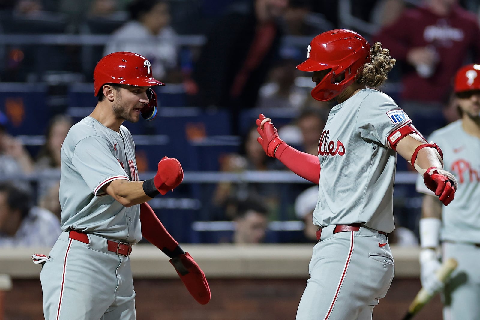 Philadelphia Phillies' Alec Bohm is congratulated by Trea Turner, left, after hitting a three-run home run during the fourth inning of a baseball game against the New York Mets, Friday, Sept. 20, 2024, in New York. (AP Photo/Adam Hunger)