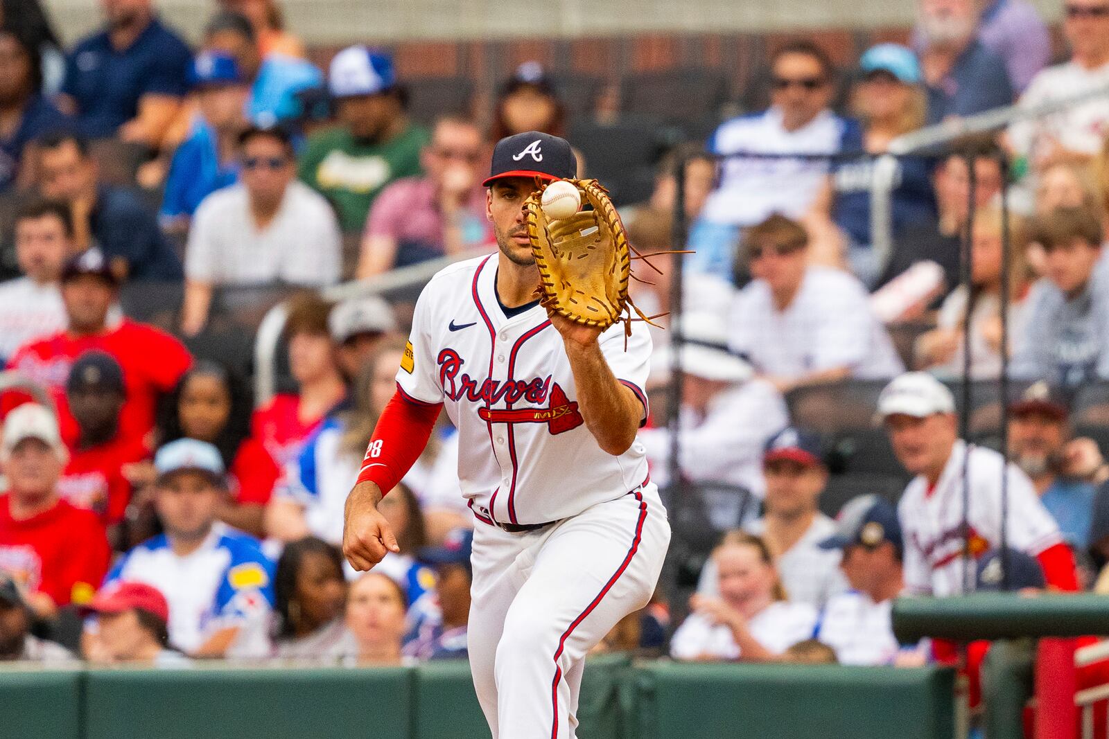 Atlanta Braves first baseman Matt Olson catches a throw before Kansas City Royals' Bobby Witt Jr. can reach first base in the fifth inning of a baseball game, Sunday, Sept. 29, 2024, in Atlanta. (AP Photo/Jason Allen)