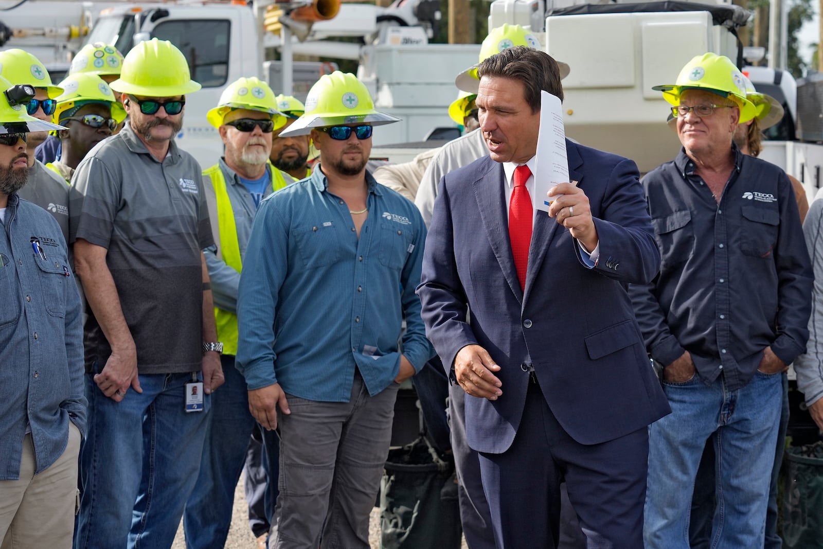 Florida Gov. Ron DeSantis, second from right, speaks to linemen before a news conference, Wednesday, Sept. 25, 2024, at the Tampa Electric Company offices in Tampa, Fla., as Tropical Storm Helene, expected to become a hurricane, moves north along Mexico’s coast toward the U.S. (AP Photo/Chris O'Meara)