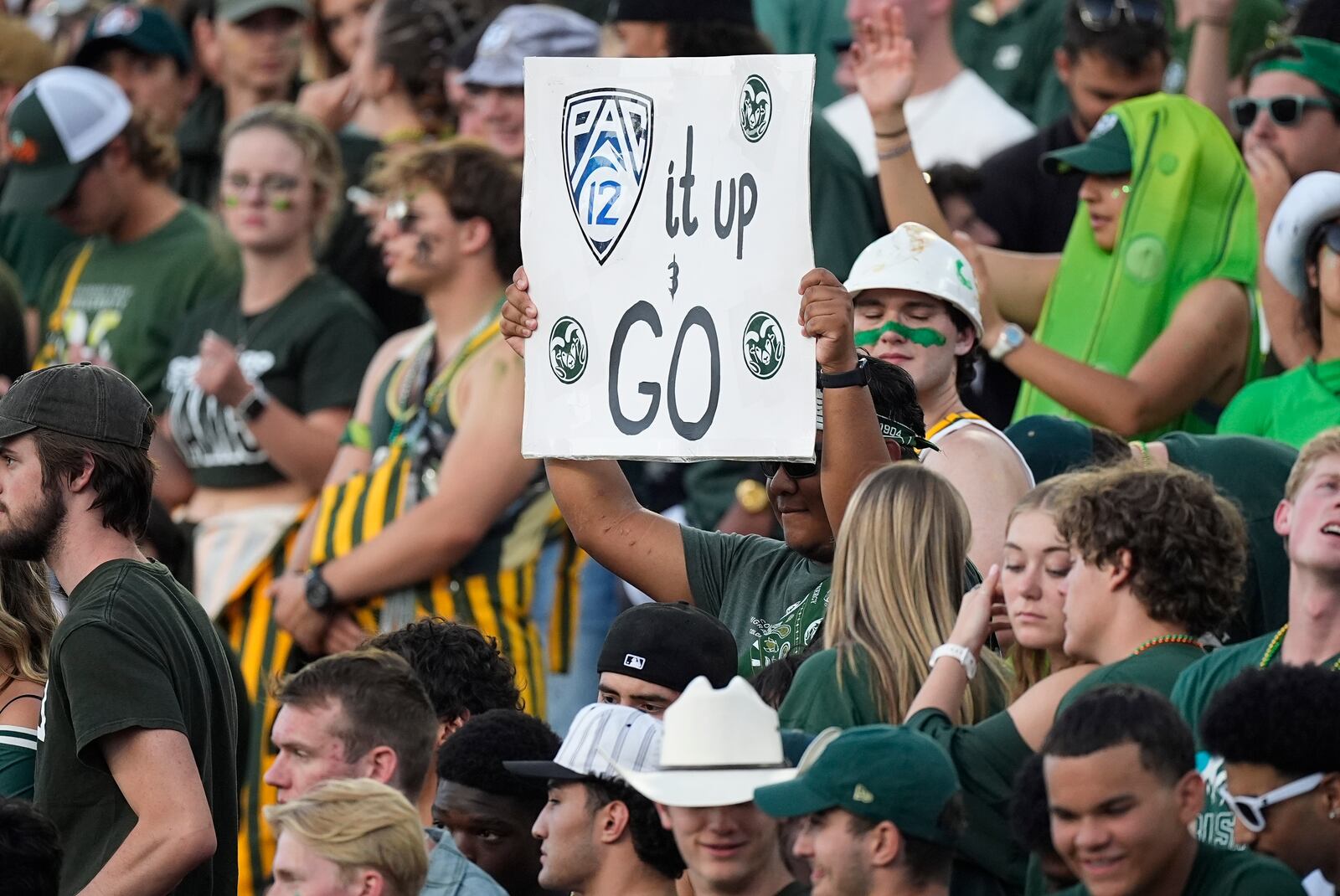 A Colorado State fan holds up a sign to mark the school's move to the Pac-12 Conference from the Mountain West during the first half of an NCAA college football game against Colorado, Saturday, Sept. 14, 2024, in Fort Collins, Colo. (AP Photo/David Zalubowski)