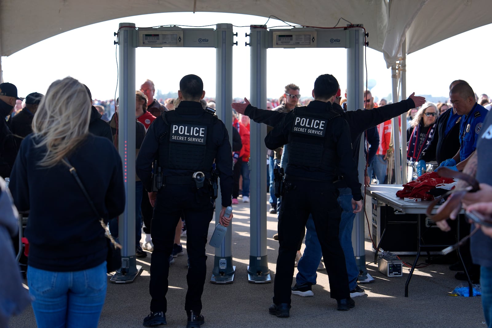 Attendees pass through security as they enter a campaign rally for Republican presidential nominee former President Donald Trump at Dodge County Airport, Sunday, Oct. 6, 2024, in Juneau, Wis. (AP Photo/Julia Demaree Nikhinson)