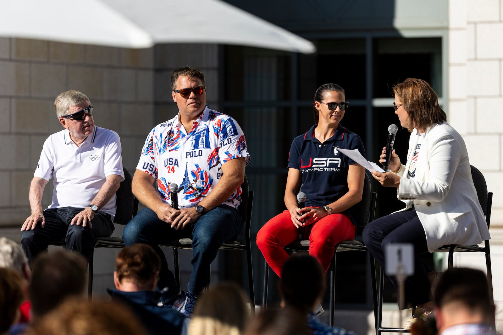 Salt Lake City-Utah 2034 Board Chair Catherine Raney Norman, right, moderates a panel comprised of, from left, International Olympic Committee President Thomas Bach, Paralympic discus medalist David Blair and Olympic speedskating medalist Brittany Bowe during a breakfast celebration held in the gardens of the Grand America Hotel in Salt Lake City, Saturday, Sept. 28, 2024.(Isaac Hale/The Deseret News via AP)