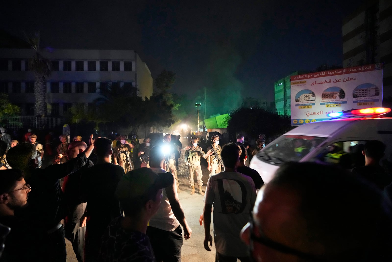 Rescuers arrive near the site of an Israeli airstrike in Beirut's southern suburbs, Friday, Sept. 27, 2024. (AP Photo/Hassan Ammar)