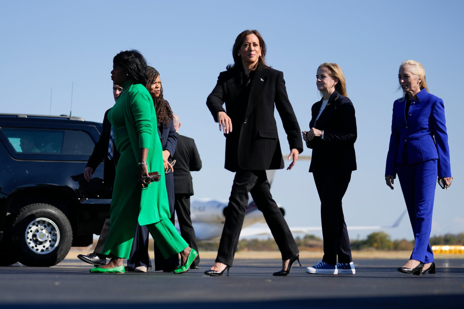 Democratic presidential nominee Vice President Kamala Harris arrives on Air Force Two in Philadelphia, Wednesday, Oct. 23, 2024. Harris was greeted by from left, Philadelphia Mayor Cherelle Parker (green), Harris, Rep. Madeleine Dean, D-Pa., (black), and Rep. Mary Gay Scanlon, D-Pa., (blue). (AP Photo/Matt Rourke)