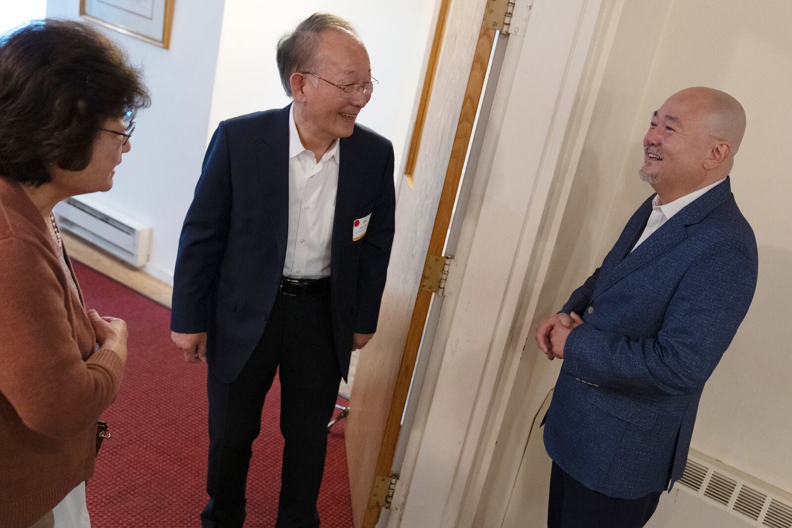 Dr. Soong-Chan Rah, right, speaks with Steve Hahn and his wife Kyung-Ae Kim Hahn at the Korean Church of Boston, Saturday, Sept. 7, 2024, in Brookline, Mass. (AP Photo/Michael Dwyer)