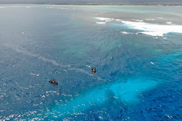 In this photo provided by the New Zealand Defence Force, divers survey the area around HMNZS Manawanui on the southern coast of Upulo, Samoa, after the Manawanui ran aground and sank on Oct. 6. (SGT Vanessa Parker/New Zealand Defence Force via AP)