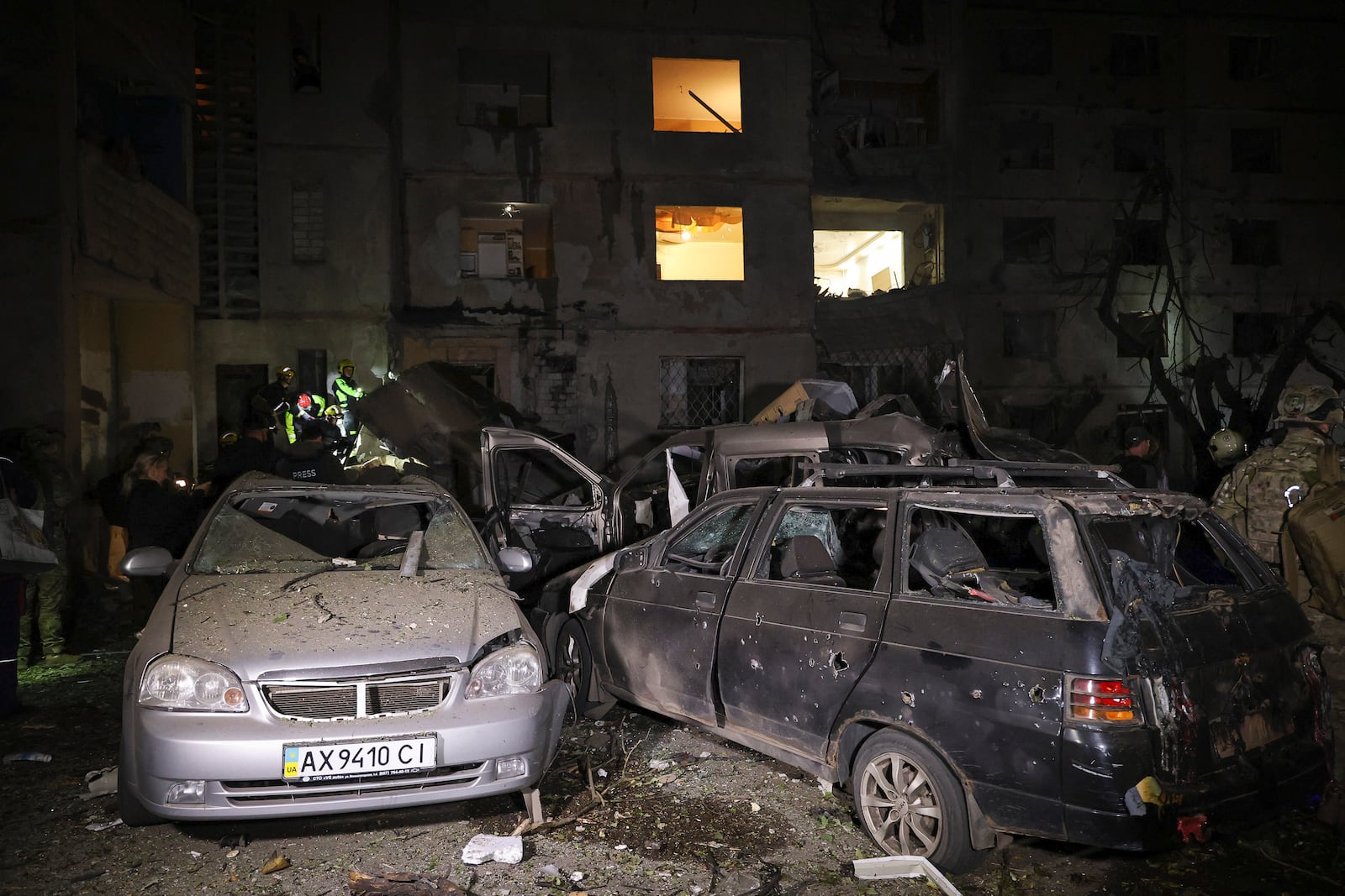 Emergency services workers move rubble after a Russian strike on a residential building in Kharkiv, Ukraine early Sunday Sept. 22, 2024. (Kharkiv Regional Military Administration via AP)