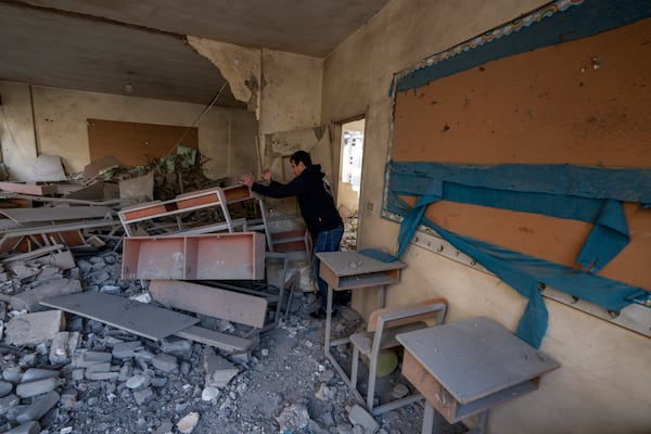 Teacher Ahmed Awada inspects his school that was damaged by an Israeli airstrike in Dahiyeh, Beirut, Lebanon, Friday, Nov. 29, 2024. (AP Photo/Bilal Hussein)