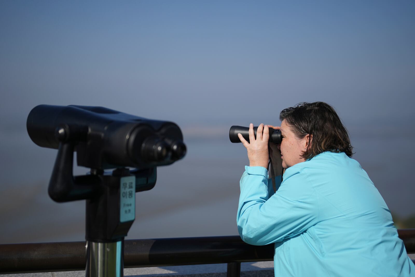 A visitor looks at the North Korean side from the unification observatory in Paju, South Korea, Thursday, Oct. 31, 2024. (AP Photo/Lee Jin-man)