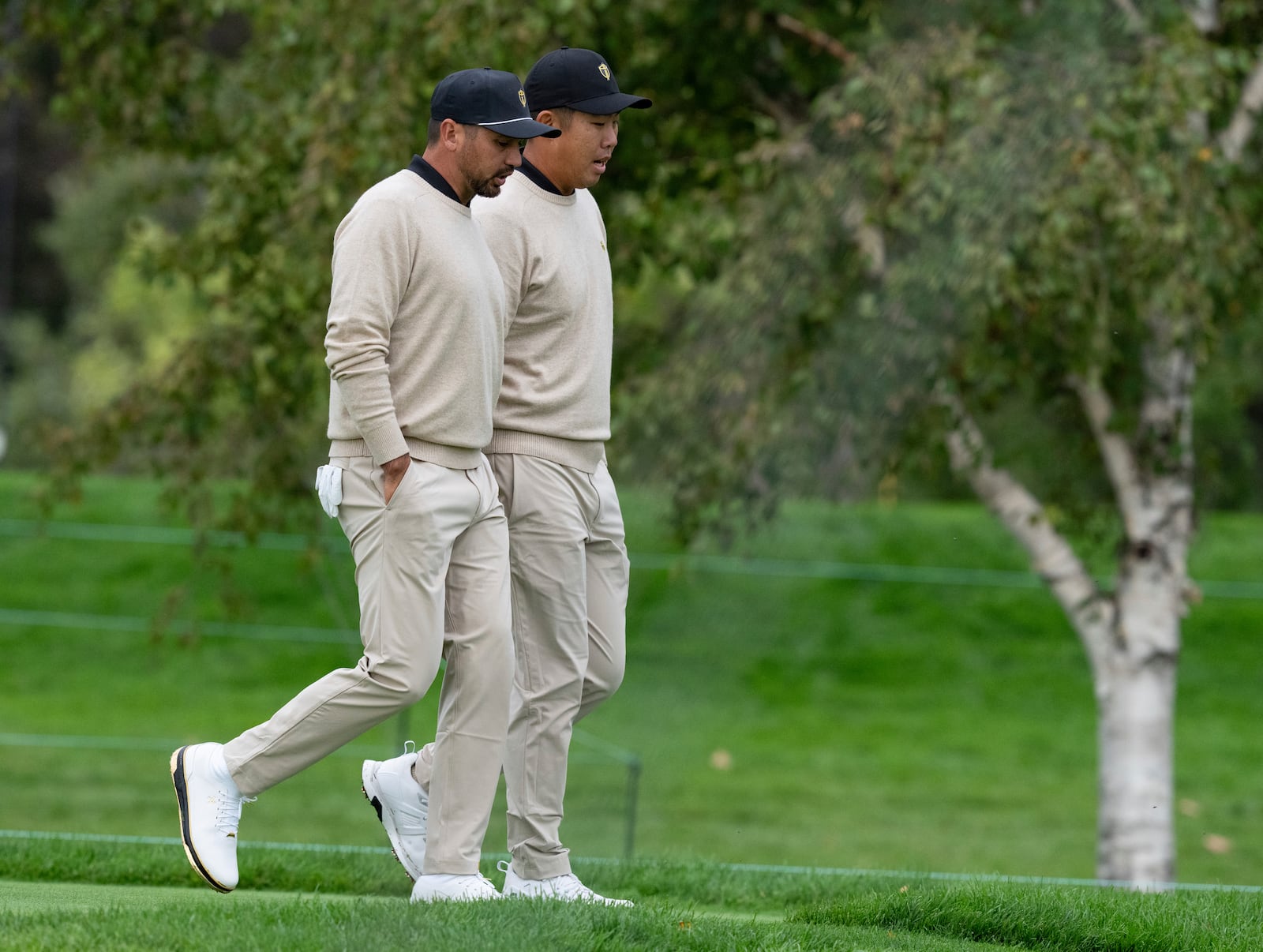 International team members Jason Day, of Australia, left, and Sungjae Im, of South Korea, walk together during practice at the Presidents Cup golf tournament at Royal Montreal Golf Club in Montreal, Tuesday, Sept. 24, 2024. (Graham Hughes/The Canadian Press via AP)