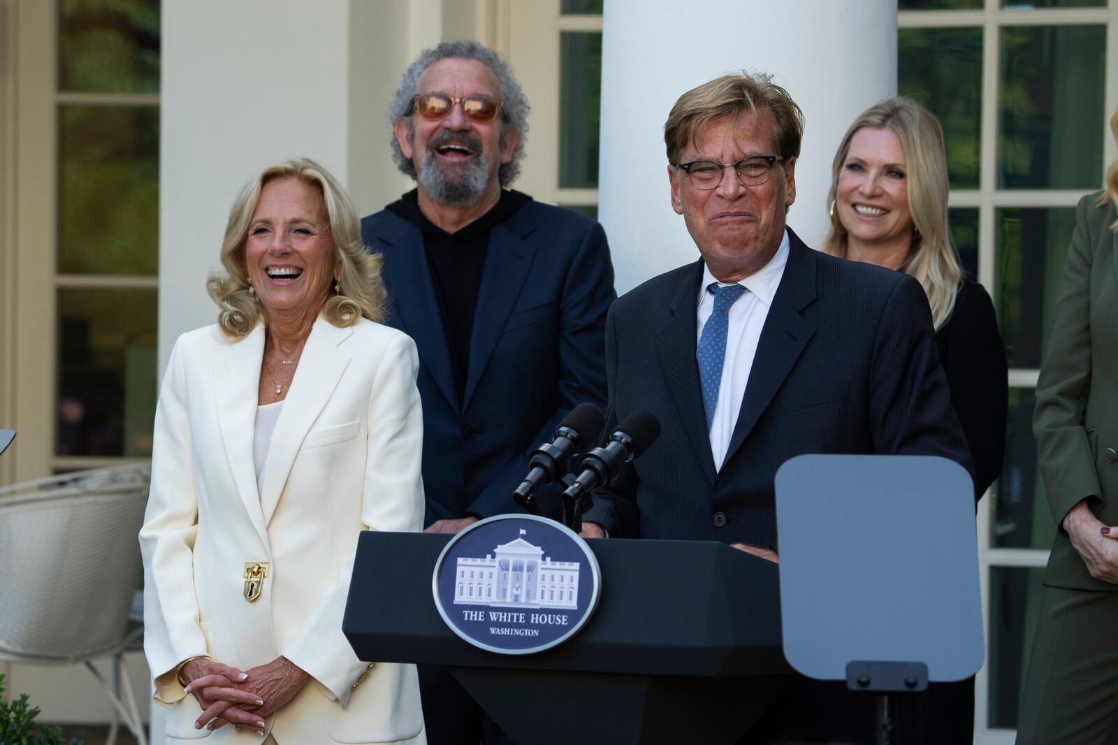 First lady Jill Biden, listens to Aaron Sorkin speak at an event on the Rose Garden at the White House to mark the 25th anniversary of the television series, The West Wing, Friday, Sept. 20, 2024, in Washington. (AP Photo/Manuel Balce Ceneta)