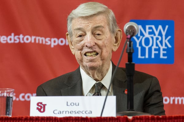 FILE - Former St. John's men's basketball coach Lou Carnesecca smiles during a news conference to announce the hiring of his former player and retired NBA basketball All-Star Chris Mullin, on April 1, 2015, in New York. (AP Photo/John Minchillo, File)