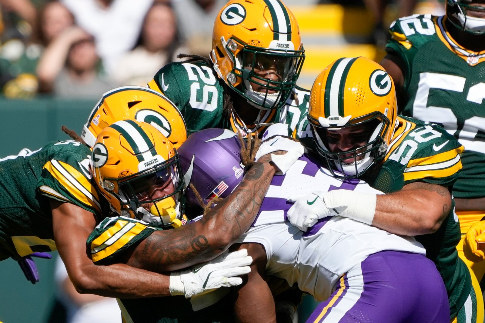 Green Bay Packers defenders tackle Minnesota Vikings running back Aaron Jones, center, during the first half of an NFL football game Sunday, Sept. 29, 2024, in Green Bay, Wis. (AP Photo/Morry Gash)