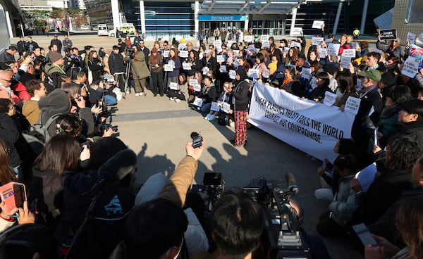 Environment activists hold a press conference calling for a strong global plastics treaty outside of the venue for the fifth session of the Intergovernmental Negotiating Committee on Plastic Pollution in Busan, South Korea, Friday, Nov. 29, 2024. (Son Hyung-joo/Yonhap via AP)