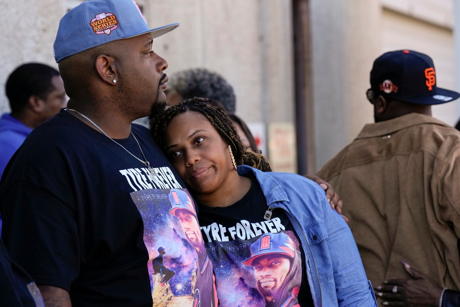 Jamal Dupree, left, and La'Toya Yizar, right, comfort each other during a prayer vigil outside the federal courthouse as jury deliberations begin for the trial of three former Memphis police officers charged in the 2023 fatal beating of their brother, Tyre Nichols, Thursday, Oct. 3, 2024, in Memphis, Tenn. (AP Photo/George Walker IV)