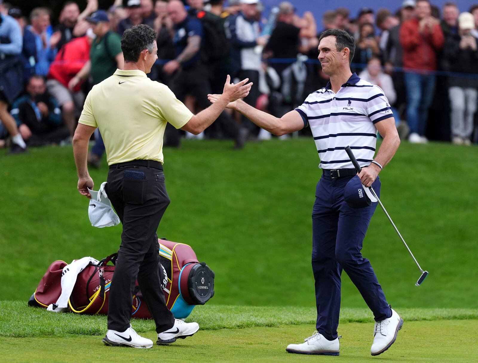 Northern Ireland's Rory McIlroy congratulates first place Billy Horschel of the U.S., following day four of the PGA Championship at Wentworth Golf Club in Virginia Water, England, Sunday Sept. 22, 2024. (Zac Goodwin/PA via AP)