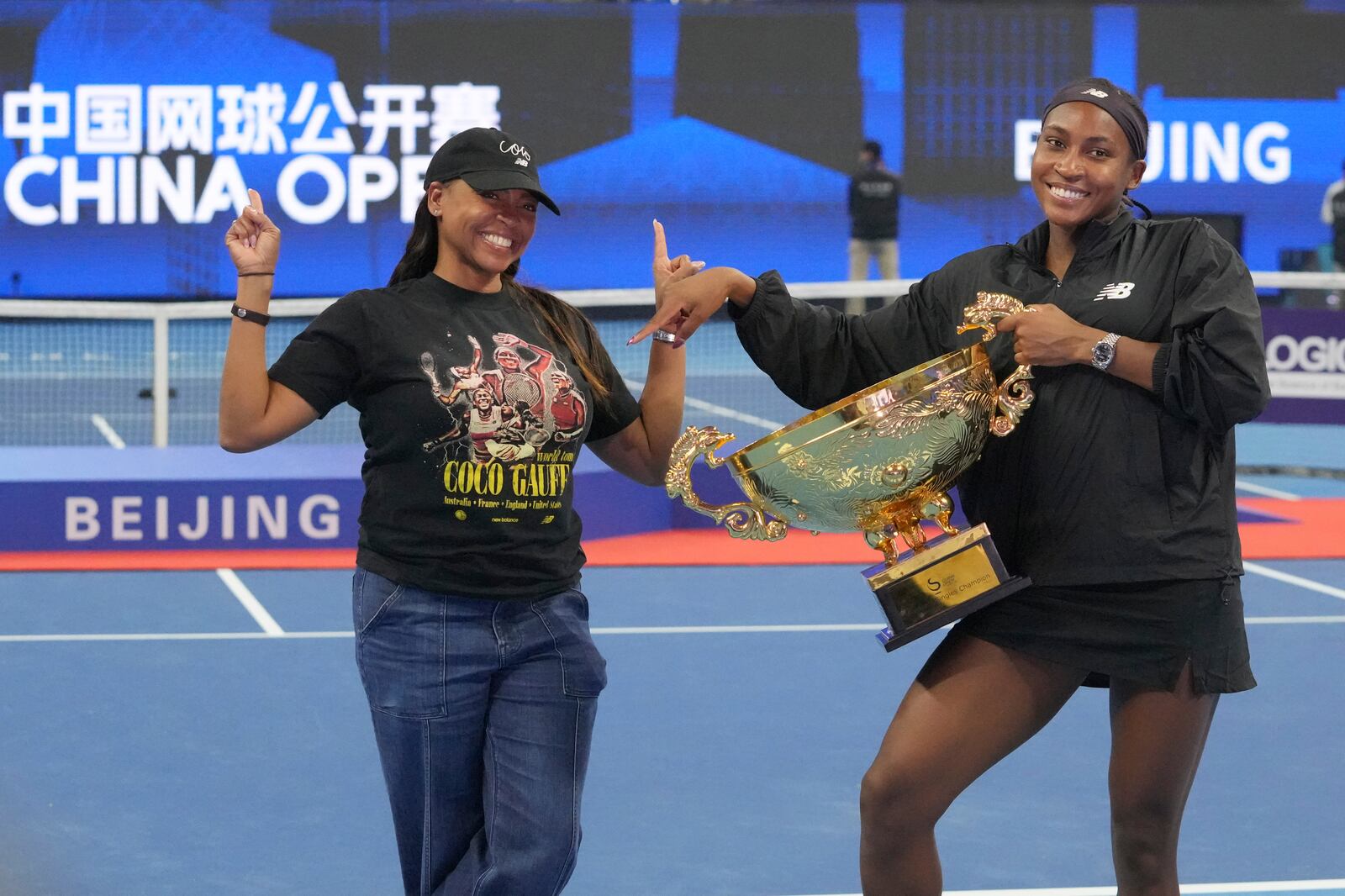 Coco Gauff of the United States, right, celebrates with her mother Candi Gauff after defeating Karolina Muchova of Czech Republic in the women's singles final match at the China Open tennis tournament at the National Tennis Center in Beijing, Sunday, Oct. 6, 2024. (AP Photo/Achmad Ibrahim)