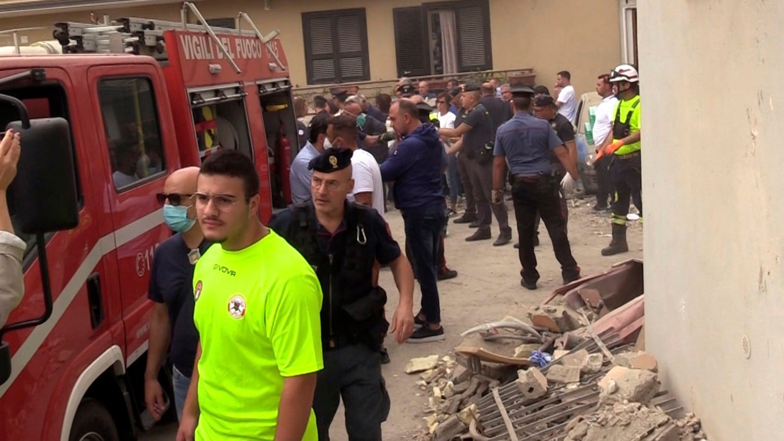 Emergency services attend the site of a building collapse in Saviano, Italy, Sunday Sept, 22, 2024. (LaPresse via AP)