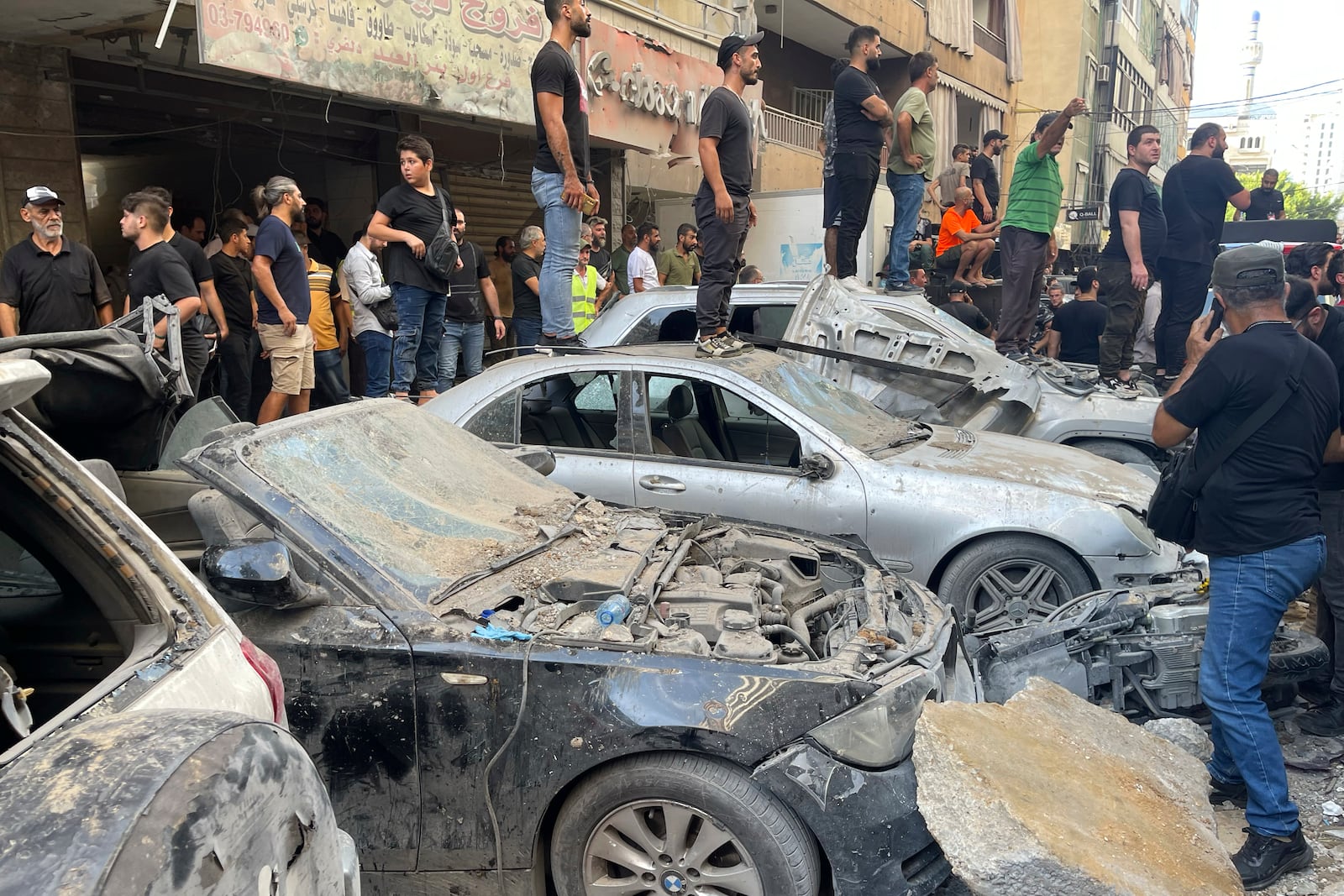 People gather at the scene of an Israeli missile strike in the southern suburbs of Beirut, Friday, Sept. 20, 2024. (AP Photo/Bilal Hussein)