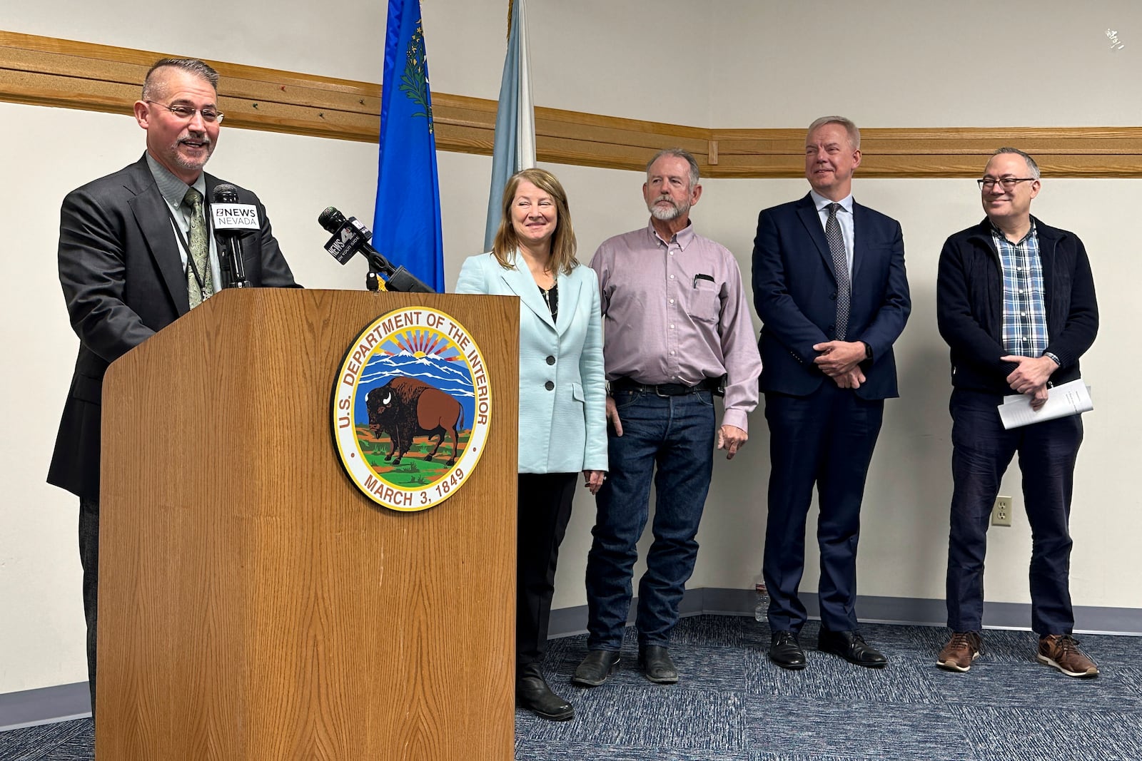 Jon Raby, left, Nevada state director for the U.S. Bureau of Land Management, speaks to reporters at BLM state headquarters in Reno, Nev., Thursday, Oct. 24, 2024, during a news conference announcing approval of a federal permit for Ioneer Ltd.'s lithium-boron mine now scheduled to begin construction next year near the California line about halfway between Reno and Las Vegas. Others who participated included (from left to right) Acting Deputy U.S. Interior Secretary Laura Daniel-Davis, Esmeralda County Commissioner Ralph Keys, Ioneer CEO Bernard Rowe and Steve Feldgus, principal deputy assistant U.S. interior secretary for land and minerals management. (AP Photo/Scott Sonner)