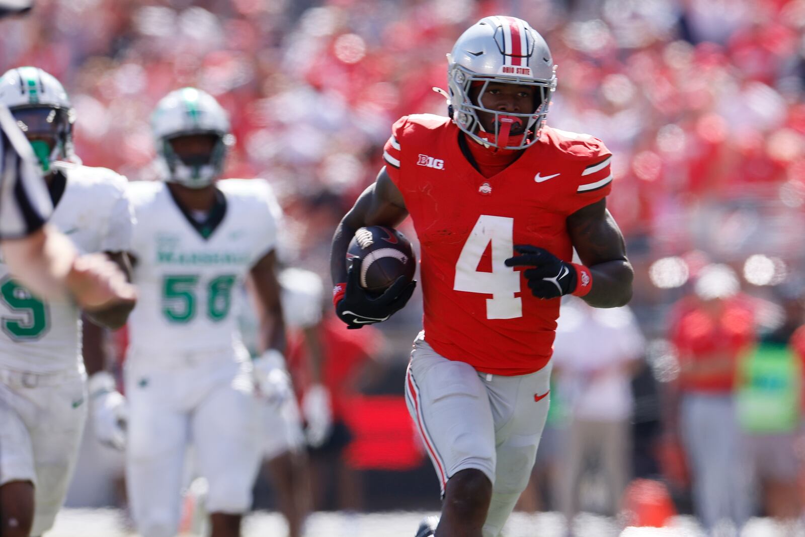 Ohio State receiver Jeremiah Smith, right, breaks away from the Marshall defense to score a touchdown during the second half of an NCAA college football game, Saturday, Sept. 21, 2024, in Columbus, Ohio. (AP Photo/Jay LaPrete)