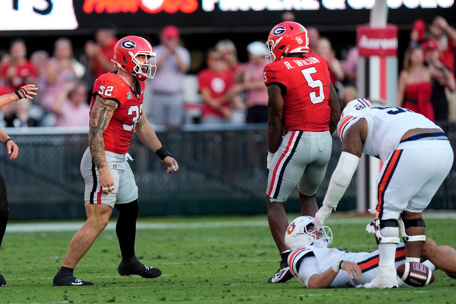 Georgia linebackers Chaz Chambliss (32) and Raylen Wilson (5) reacts after Georgia sacked Auburn quarterback Payton Thorne, right, in the second half of an NCAA college football game Saturday, Oct. 5, 2024, in Athens, Ga. (AP Photo/John Bazemore)