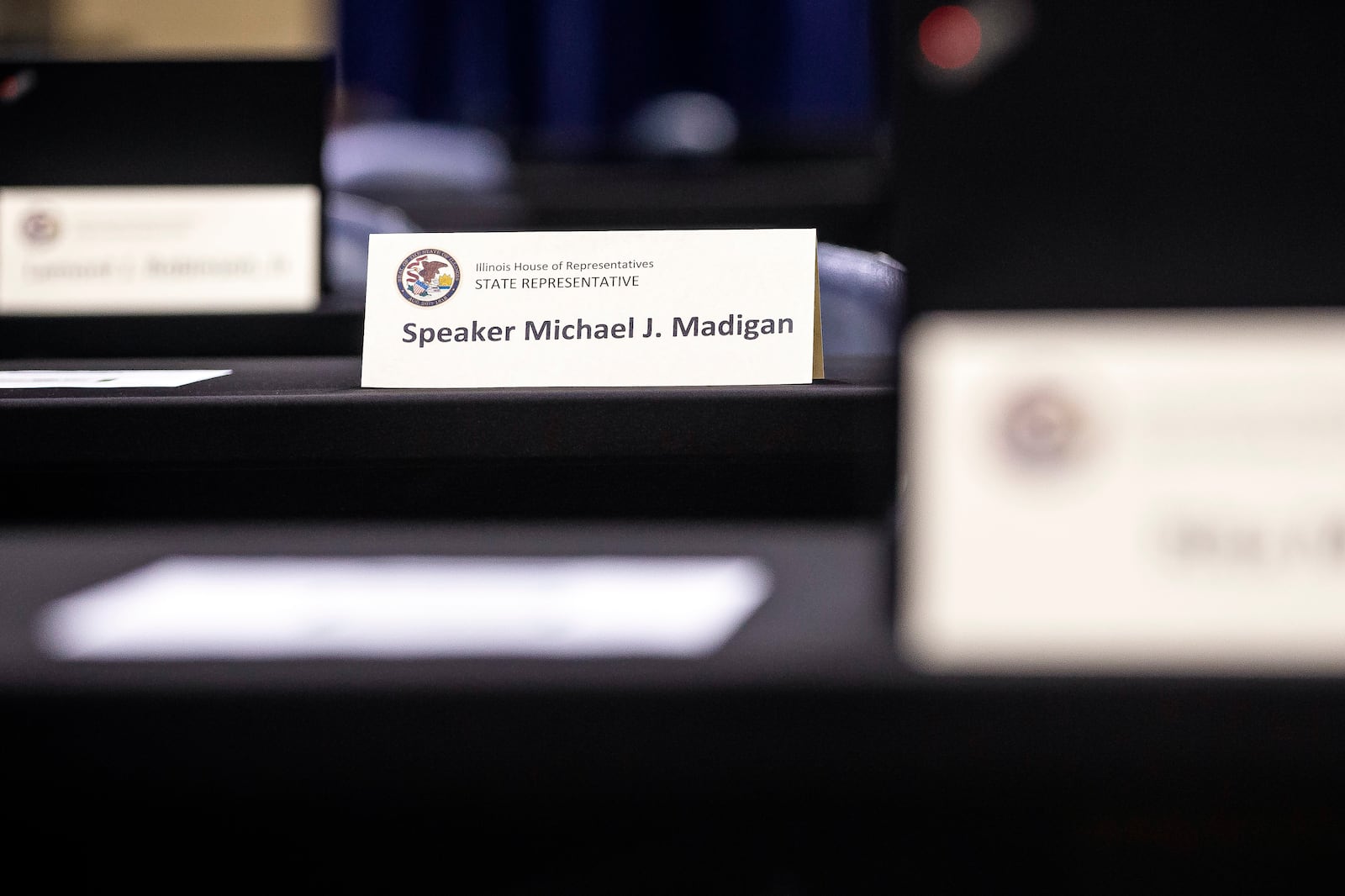 FILE - In this Jan. 7, 2021 file photo, the nameplate marking the desk of then-Illinois Speaker of the House Michael Madigan, D-Chicago, is seen on a desk as the main floor of the Bank of Springfield Center as the Illinois House of Representatives get set to hold a lame-duck legislative session session in Springfield, Ill. (Justin L. Fowler/The State Journal-Register via AP, File)