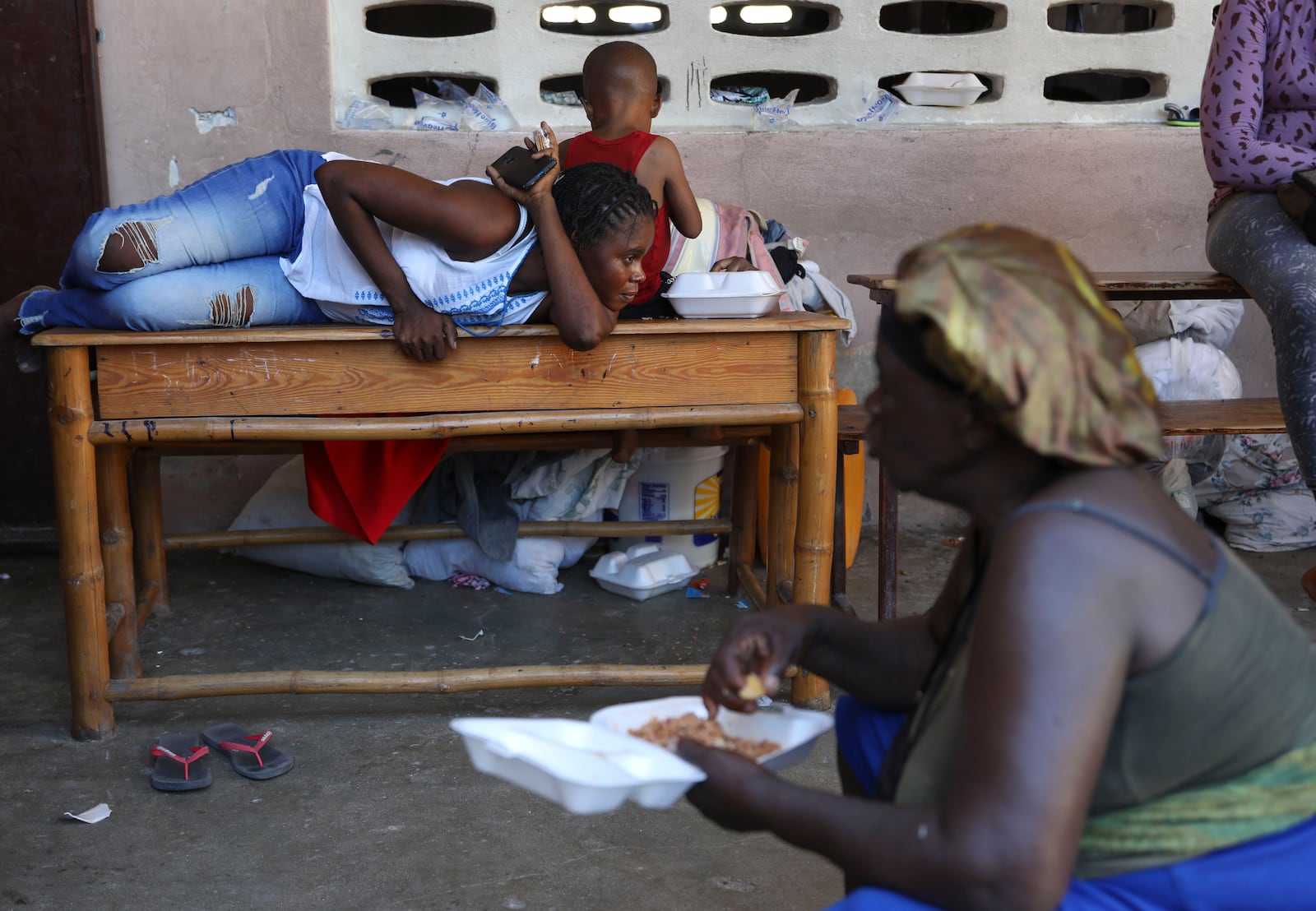 People displaced by armed gang attacks rest at the Antoinette Dessalines National School, a makeshift shelter, in Saint-Marc, Haiti, Sunday, Oct. 6, 2024. (AP Photo/Odelyn Joseph)