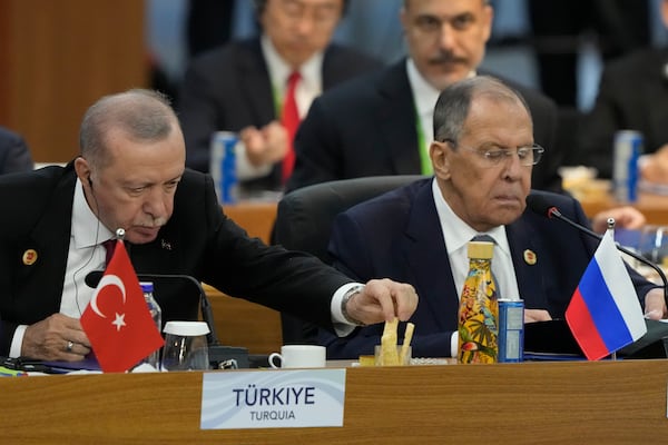 Turkey's President Recep Tayyip Erdogan, left, and Russia's Foreign Minister Sergey Lavrov attend the G20 Summit leaders meeting in Rio de Janeiro, Monday, Nov. 18, 2024. (AP Photo/Eraldo Peres)