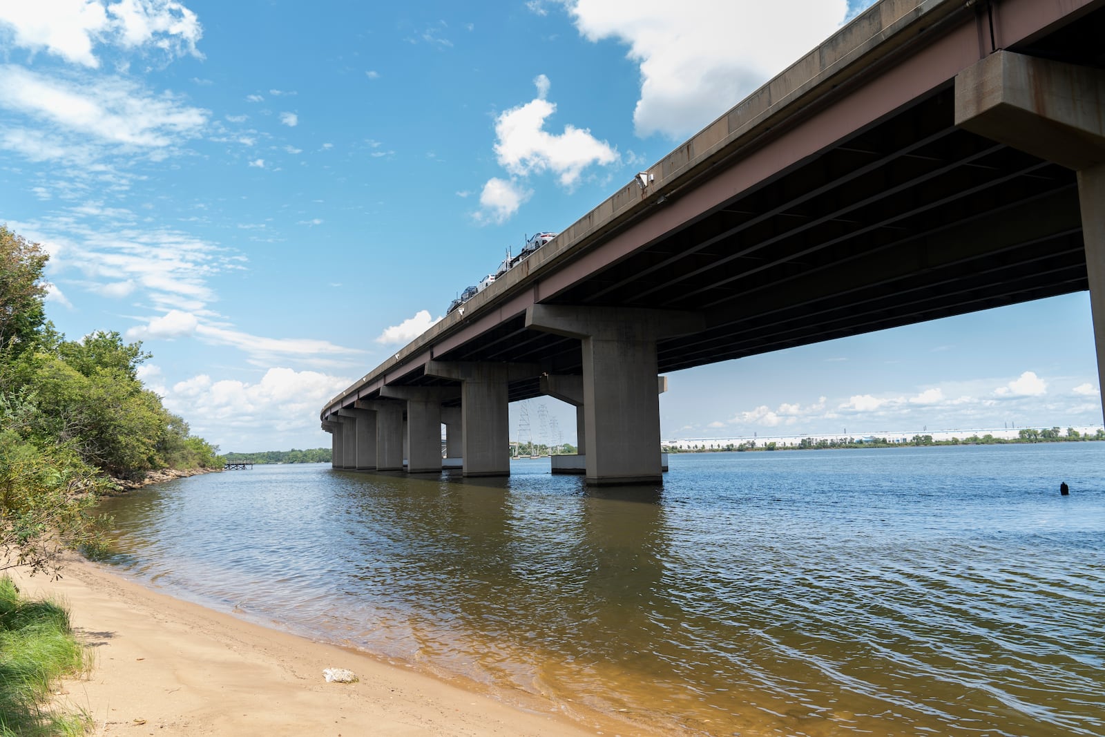 A small beach below the remaining portion of the Francis Scott Key Bridge is seen, Tuesday, Aug. 13, 2024, in Turner Station, Md. The water is unsafe for swimming and fishing from decades of industrial pollution. (AP Photo/Stephanie Scarbrough)