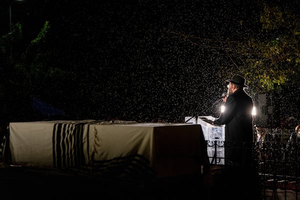 A rabbi delivers an eulogy next to the coffin containing the remains of Israeli-Moldovan rabbi Zvi Kogan in Kfar Chabad, Israel, Monday Nov. 25, 2024. Kogan, 28, an ultra-Orthodox rabbi, was killed last week in Dubai where he ran a kosher grocery store. Israelis have flocked for commerce and tourism since the two countries forged diplomatic ties in the 2020 Abraham Accords.(AP Photo/Ohad Zwigenberg)