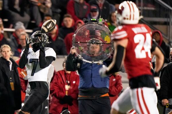 Oregon's Evan Stewart (7) catches a pass during the first half of an NCAA college football game against Wisconsin Saturday, Nov. 16, 2024, in Madison, Wis. (AP Photo/Morry Gash)