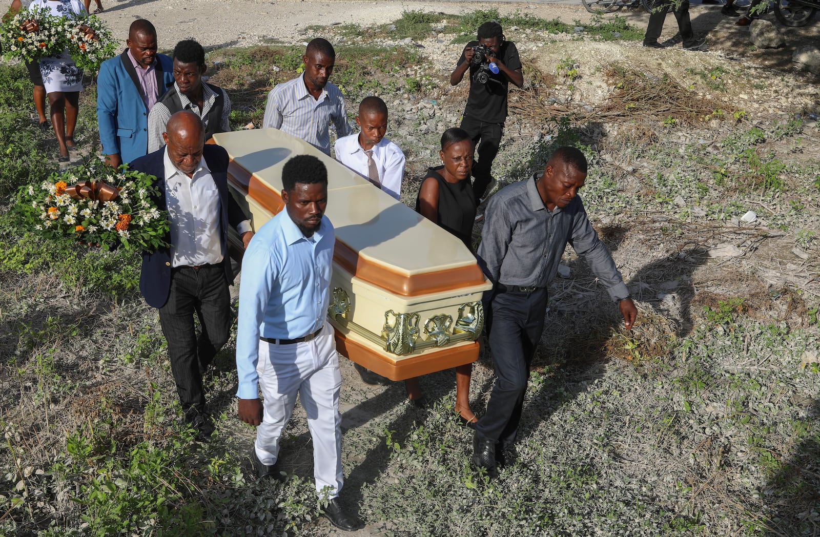 Relatives carry the coffin of Jean Louis Jeune Gracien, who was killed during an attack by armed gangs, at his funeral in Pont-Sonde, Haiti, Tuesday, Oct. 8, 2024. (AP Photo/Odelyn Joseph)