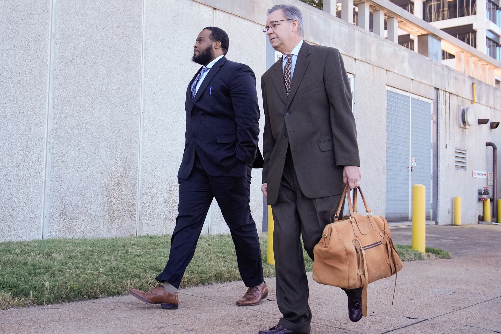 Demetrius Haley, left, one of three former Memphis police officers charged in the 2023 fatal beating of Tyre Nichols, arrives at the federal courthouse with his attorney Michael Stengel, right, for the day's proceedings Thursday, Oct. 3, 2024, in Memphis, Tenn. (AP Photo/George Walker IV)