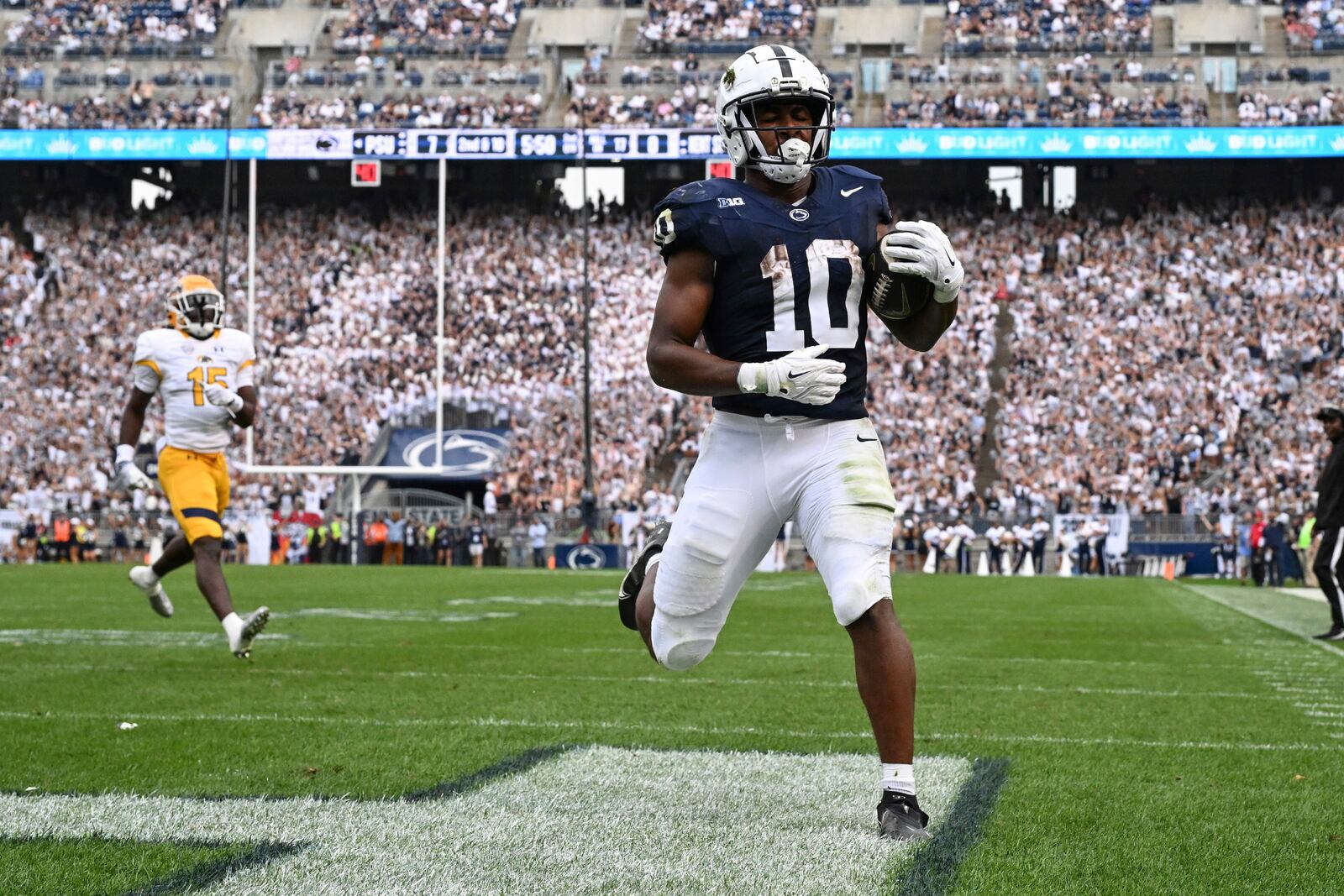 Penn State running back Nicholas Singleton (10) scores a touchdown while being chased by Kent State cornerback Dallas Branch (15) during the second quarter of an NCAA college football game, Saturday, Sept. 21, 2024, in State College, Pa. (AP Photo/Barry Reeger)