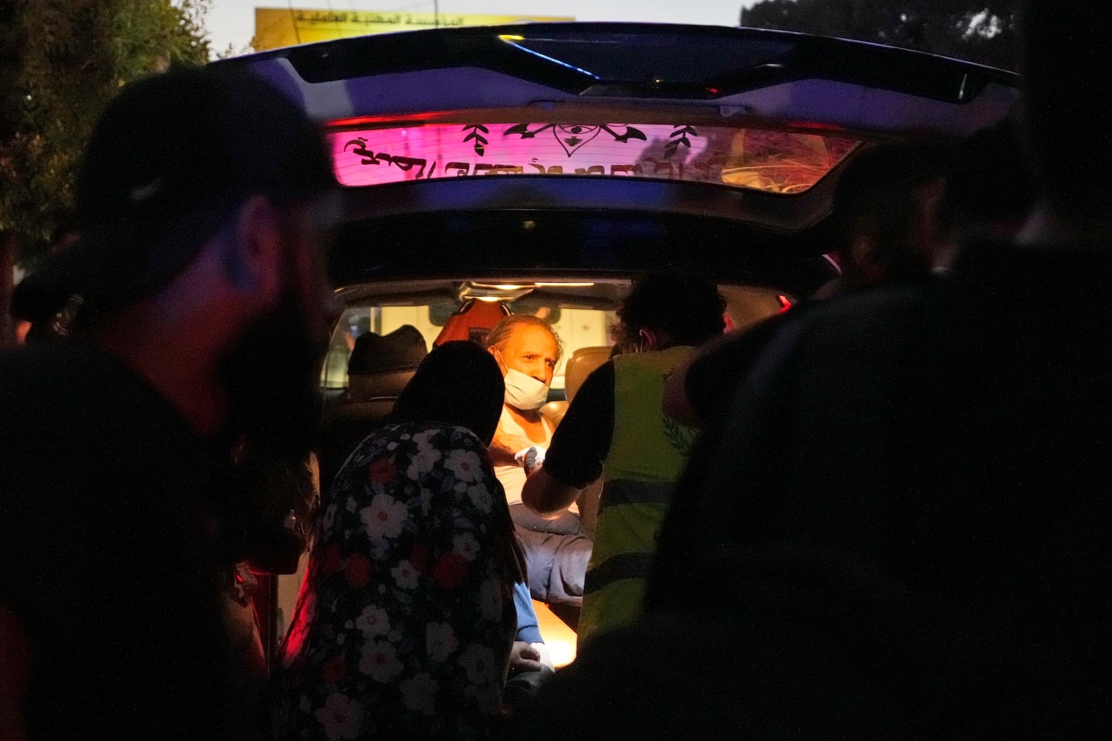 A wounded man sits in an ambulance at the site of an Israeli airstrike in Beirut's southern suburbs, Friday, Sept. 27, 2024. (AP Photo/Hassan Ammar)