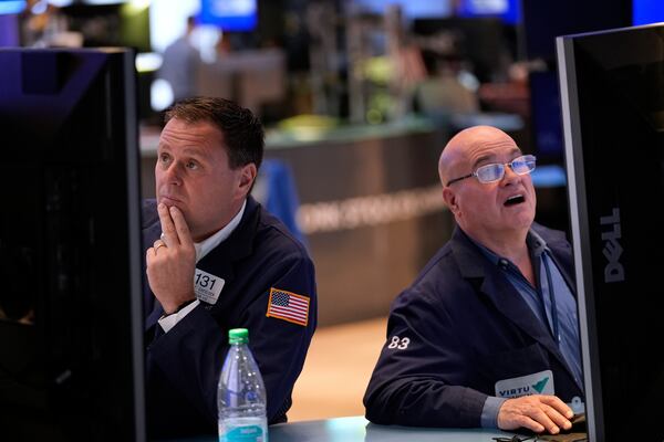 Matthew Cheslock, left, and Anthony Confusione work on the floor at the New York Stock Exchange in New York, Wednesday, April 30, 2025. (AP Photo/Seth Wenig)