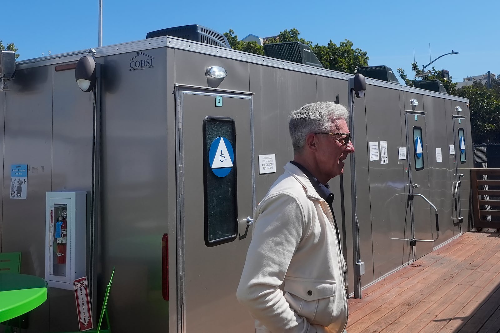 Steve Good, CEO of Five Keys, walks past restrooms at the Five Keys' Mission Cabins transitional housing location in San Francisco, Monday, Aug. 26, 2024. (AP Photo/Jeff Chiu)